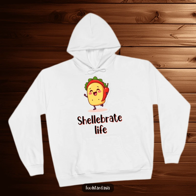 Funny hoodie depicting a cheerful taco with legs dancing with a chili pepper, offering warmth and a humorous fiesta vibe.